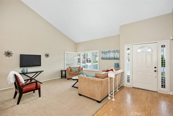 Living room with double pane windows and high ceilings.
