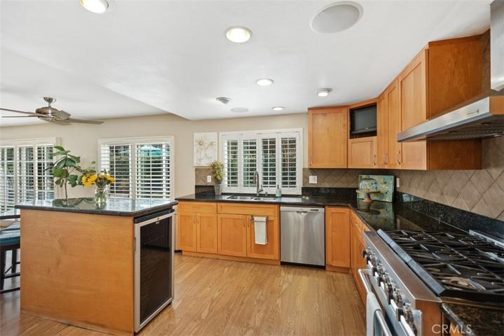Wow!  Look at this spacious remodeled kitchen with stainless steal appliances, 2 ovens with 6 burner gas range & a wine fridge.