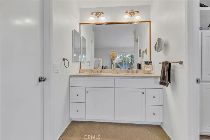 Dual sinks in primary bath with a walk-in closet