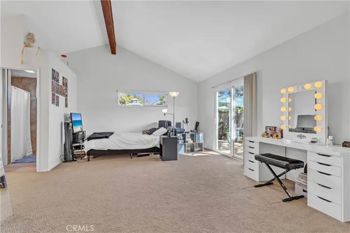 Large primary suite with vaulted ceilings and access to the backyard
