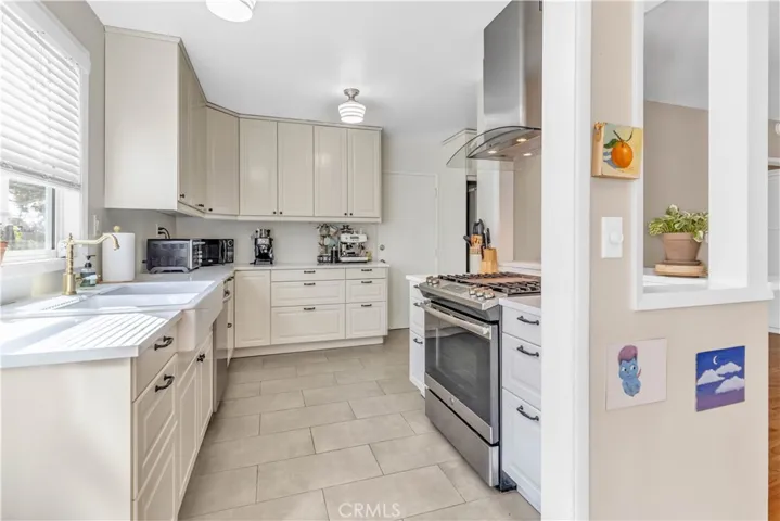Remodeled kitchen with newer appliances and farmhouse double sink