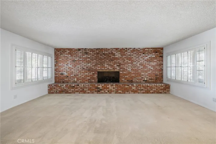Family room with fireplace opposite end of Living room Fireplace