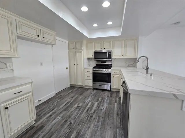 Updated kitchen has direct access to the 2 car garage and laundry area.