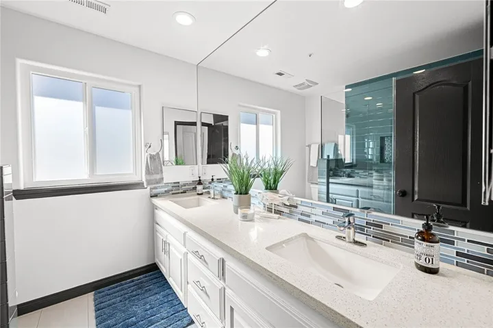 Full bathroom upstairs with double vanities