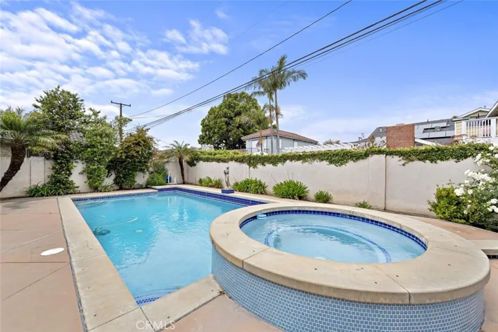 Enjoy a cold glass of lemonade while sitting in your peaceful backyard by the pool and blue skies.