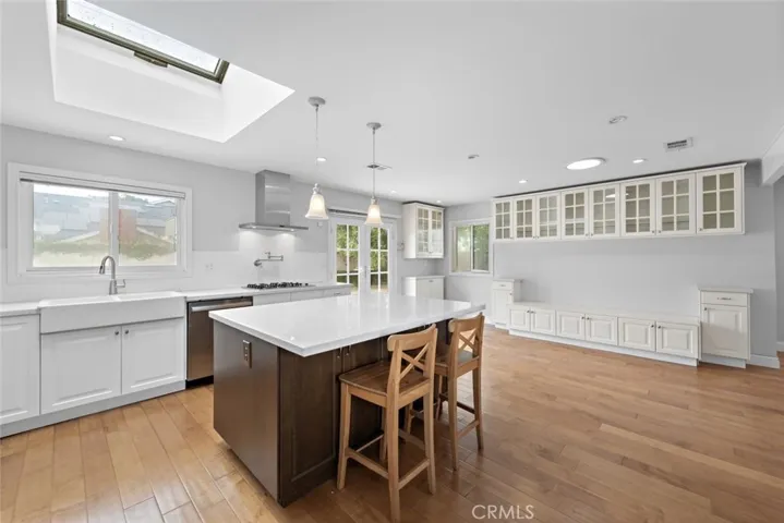 Skylights + Solar Tube Skylights throughout the home. Kitchen features spacious storage and cabinets, two tone custom cabinets, perfectly designed Kitchen w/many slow closing drawers & cabinets, recessed lightings, views into the private pool and spa, farmhouse large sink, pot filler, gas stovetop, electric oven, and appliances.