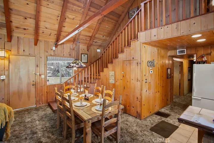 Dining area adjacent to front door and back door for extra outdoor cooking and dining space. Large under stair closet