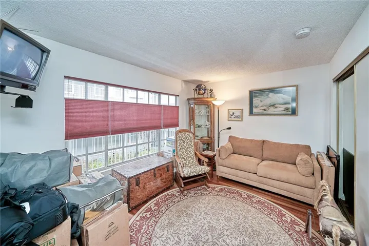 The front bedroom has deluxe hardwood flooring as well as ample closet space (pardon the boxes they're moving).