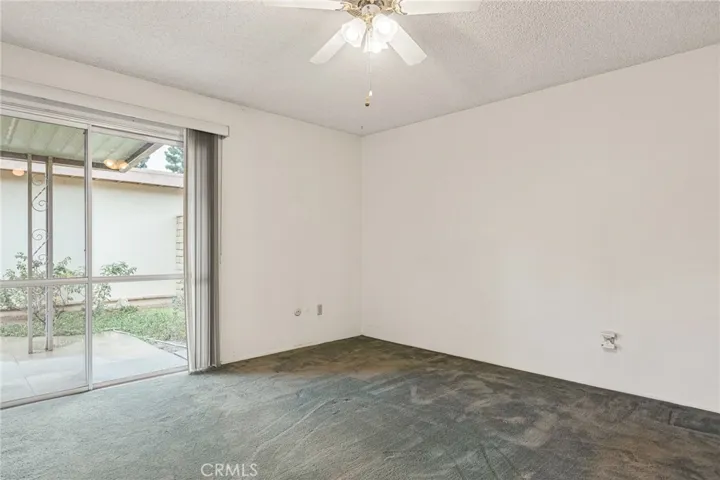 Primary bedroom opens onto back patio.