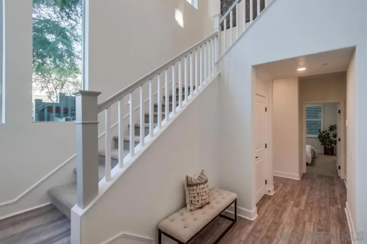 Enter to newly painted walls, white sea luxury viny plank flooring, a large hall closet, and a downstairs bedroom with en suite bathroom.