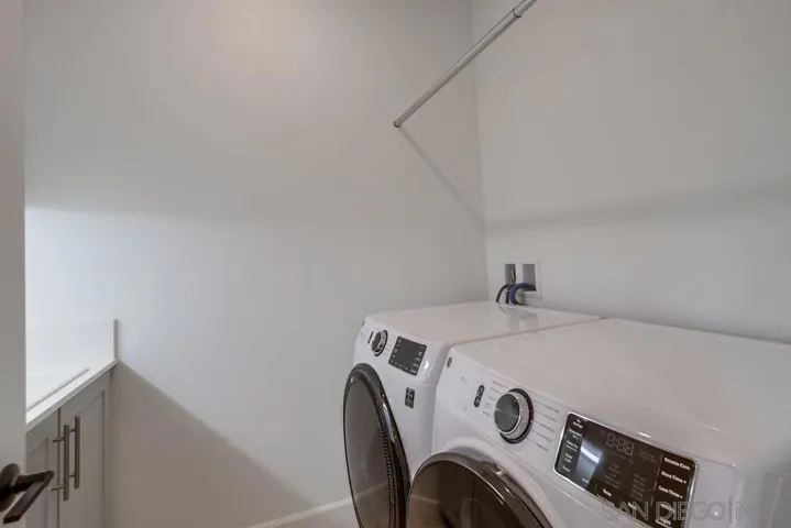 3rd floor laundry room with drying pole. G.E. Energy Star front load washer & dryer convey!