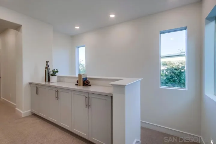 The third floor has generous linen space, the Primary bedroom, 2 additional bedrooms, a laundry room, and full bathroom.