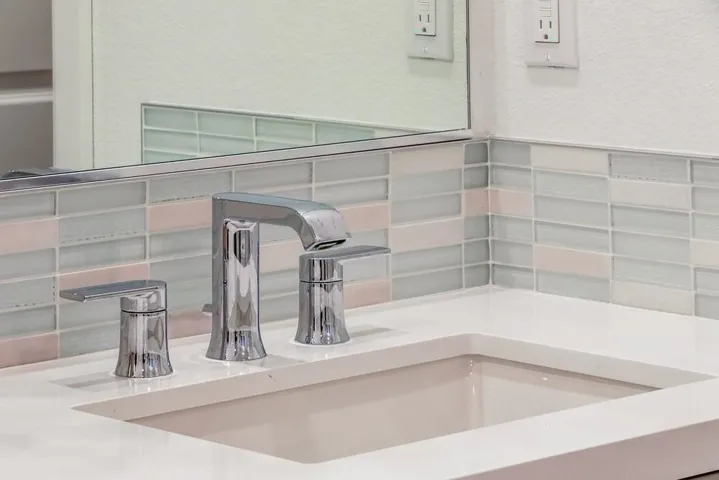 Illumina tile backsplash and Moen genta chrome faucet.