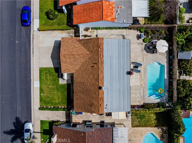 Aerial view of one story home with pool