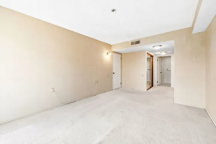 Primary bedroom facing closet and bath