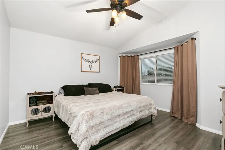 Primary bedroom with laminate flooring.
