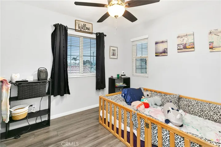 Secondary bedroom with laminate floors.