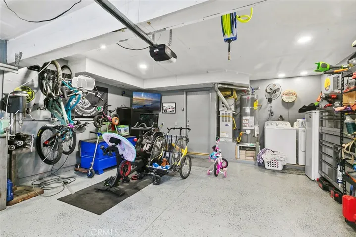 Epoxy floors in the garage with newer water heater.
