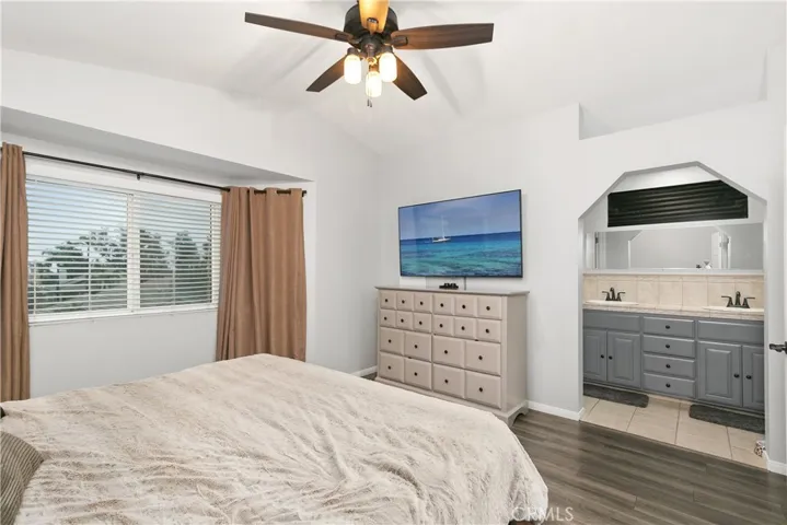 Primary bedroom with view into bathroom.