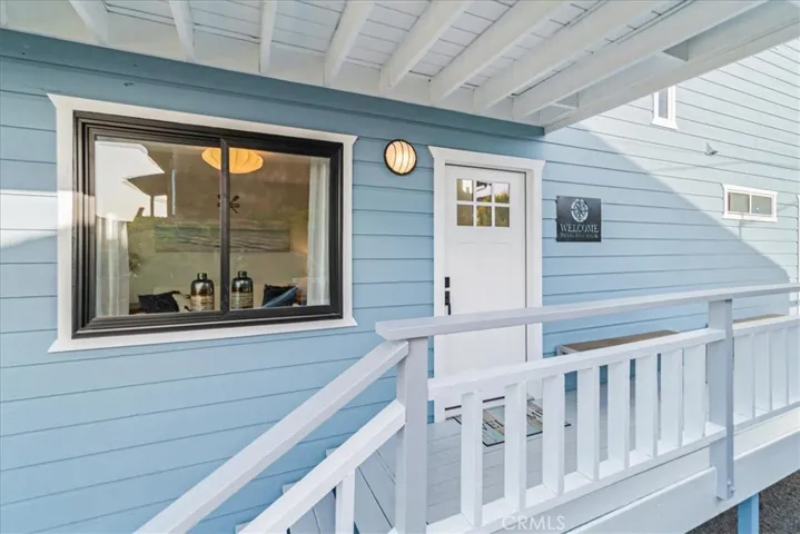 Front door entry with deck.