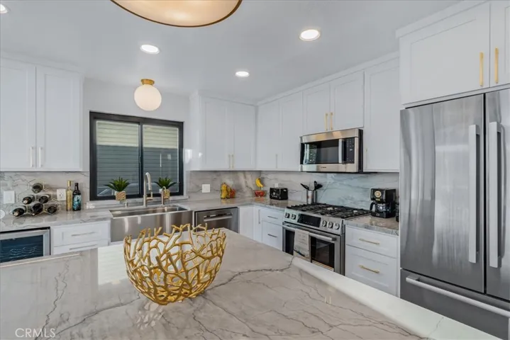 Quartz counters and backsplash throughout.