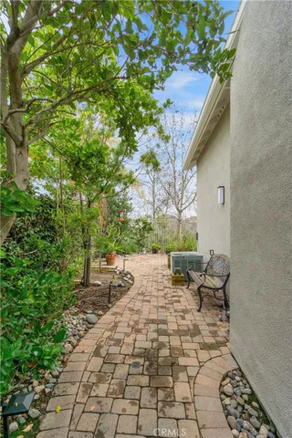 Wrap around walkway from front atrium to backyard.