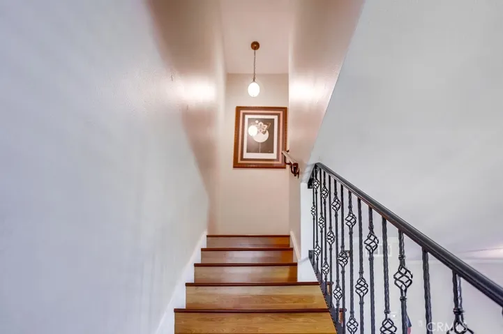 Wooden staircase with wrought iron railing