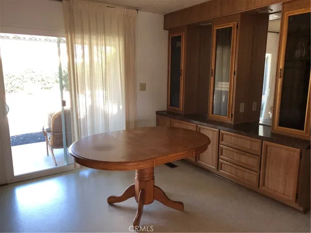 Dining Room w/built in china cabinet.  Slider to pool area.