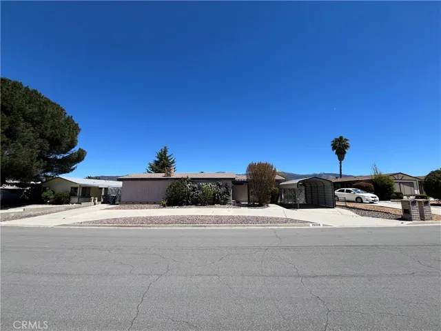 Property w/circular driveway.  Carport on right side.