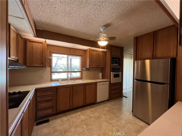 Kitchen, window overlooks patio and pool