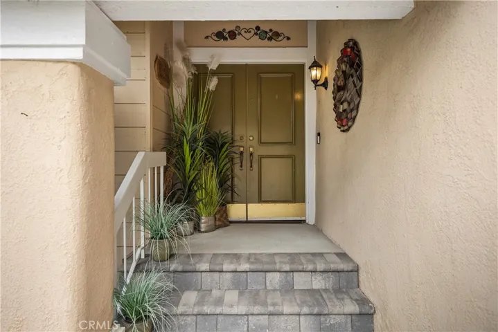 Double doors with pavers on the porch area.