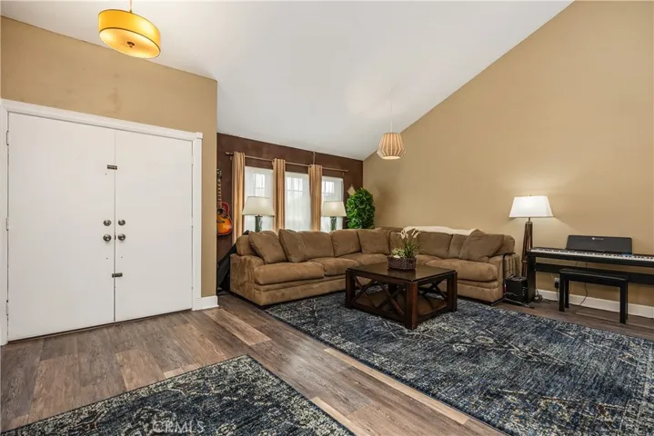 Spacious living room with high ceilings and luxury laminate flooring.