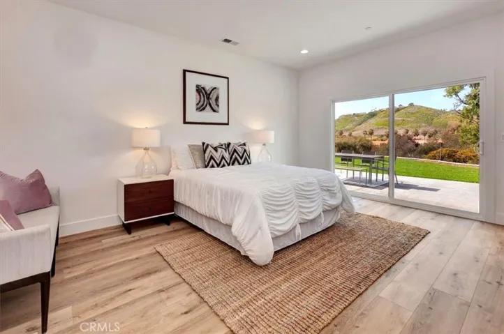 Primary Bedroom features 9’ ceilings, sliding door access to the back yard & pocket door entry to the gorgeous ensuite bath.