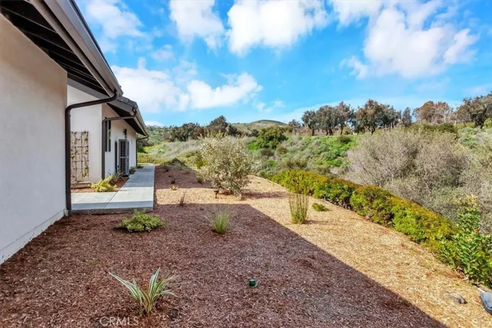 Large side yard with views of the surrounding hills.