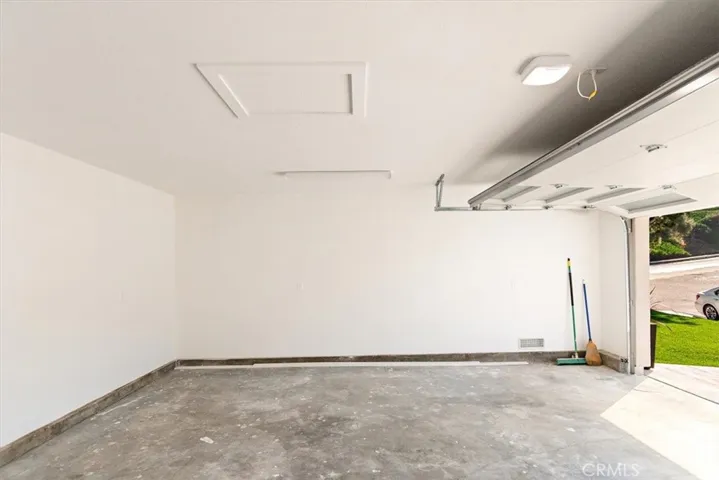 Finished garage, roll up garage door & side mount Lift Master opener.