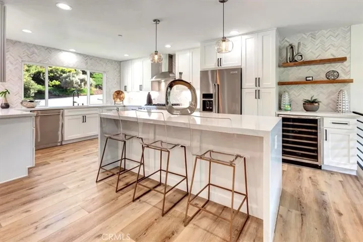 ALL NEW stainless appliances include Zline 36” dual fuel 5 burner gas range, hood vent, drawer microwave & DW, Kitchenaid counter depth frig & Frigidaire wine frig.