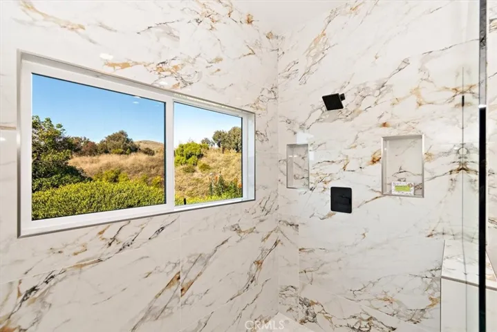 24” X 48” porcelain tile shower surround & vanity wall, & frameless glass enclosure.