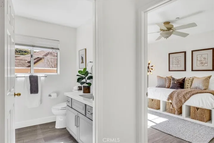 The guest bath is adjacent to the bedroom and offers a shower/tub glass enclosure.