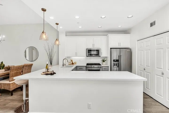 Beautifully appointed kitchen will delight the chef with quartz counters, soft-close cabinetry, stainless appliances, and plenty of storage & counter space.