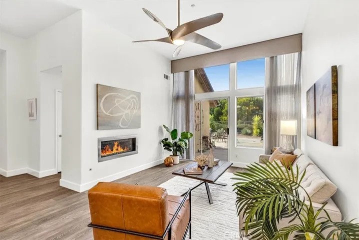 Anchored by a modern glass fireplace and vaulted ceilings in the living room create a bright & airy atmosphere.