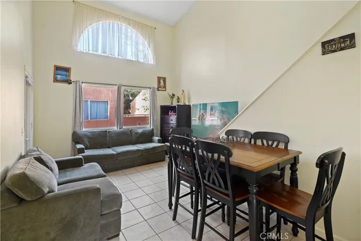Living room with high ceilings.  Stairs lead up to 2nd bedroom which was a​​‌​​​​‌​​‌‌​​‌​​​‌‌​​​‌​​‌‌​​‌‌​​‌‌​​​​ loft.