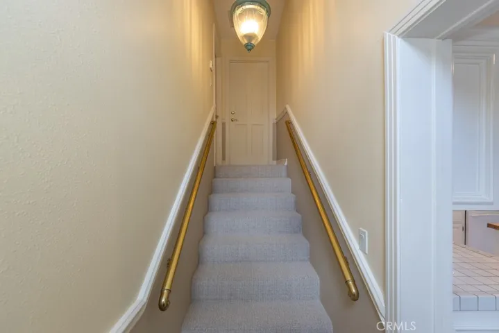 Staircase behind kitchen to bedroom 5 and bonus room