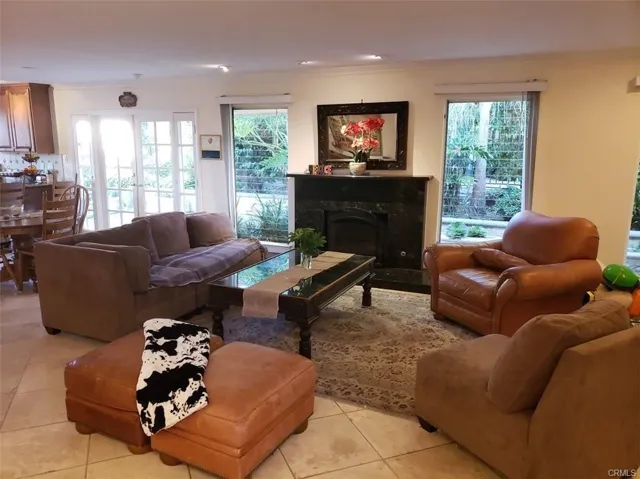 Open Living Room centered by Gas Fireplace.