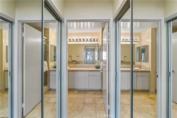 Dual Mirrored Wardrobes in Bathroom Entryway.