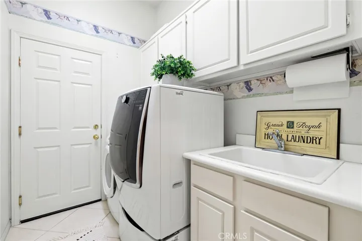 Indoor laundry room with direct access to the attached three car garage.