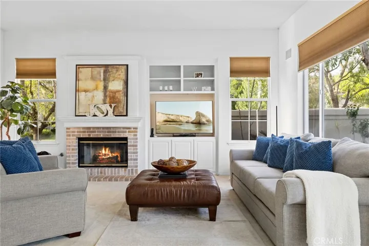 Family room with a built-in media niche and a fireplace.