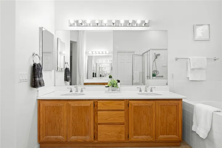Primary bathroom vanity with dual sinks.
