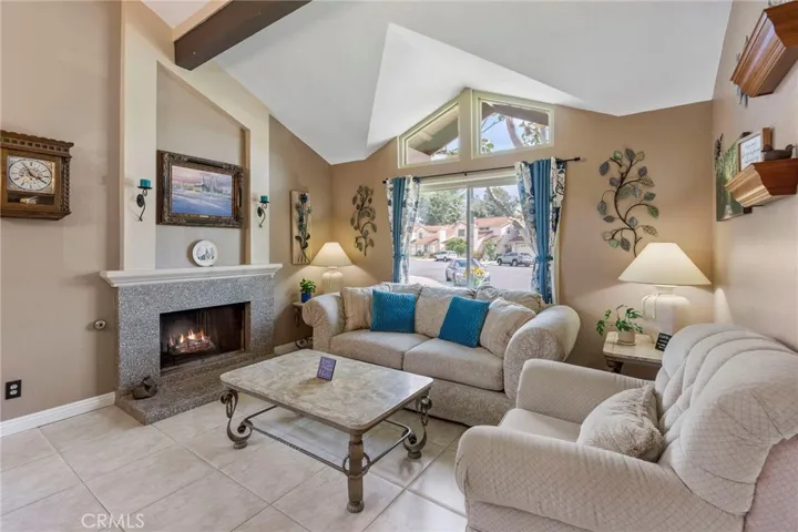 Formal Living area with granite fireplace surround and easy care tile flooring.
