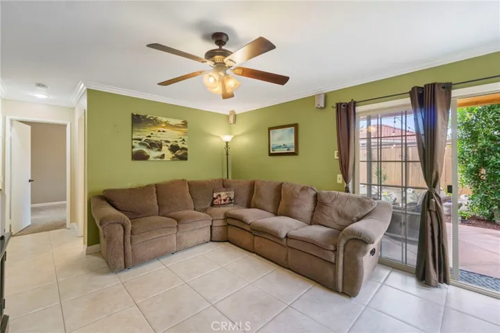 Family room area with slider to outside seating area. Open door leads to the downstairs bedroom or office area.