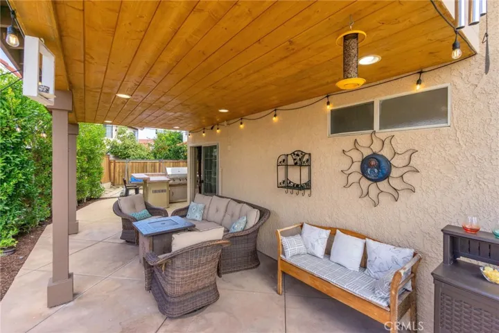Comfortable covered backyard seating area. Tongue and Groove wood ceiling with recessed lighting.